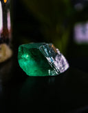 A vibrant emerald gemstone with natural facets featured in an article on gemstone legends for everett jewelry store.