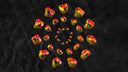 Vibrant natural diamonds in yellow and red shades arranged in a radial pattern highlighting contrast with lab grown gems