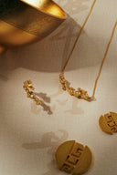 Personalized 18k gold jewelry: floral necklace, earrings, geometric medallions