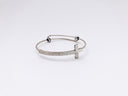 closeup photo of silver-colored cross bangle