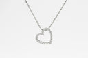 silver heart pendant necklace on white background