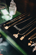 gold necklace on black box