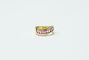 gold and black ring on white surface