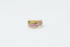 gold and black ring on white surface