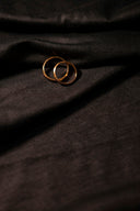 gold ring on black textile