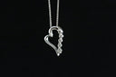 a heart shaped pendant on a black background