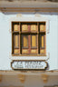 brown wooden window frame on white concrete wall
