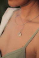 woman in green tank top wearing silver necklace