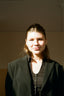 a woman in a suit posing for a picture