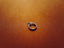 a silver ring sitting on top of a brown surface