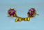 a pair of pink and gold earrings on a blue background