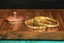 a couple of gold bracelets sitting on top of a wooden table