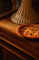 a pair of gold rings on a wooden surface