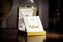 a gold box with a gold ring