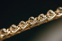 a close up of a gold chain with diamonds