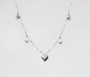 a silver heart necklace on a white background