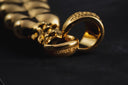 a couple of gold rings sitting on top of a table