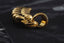 a couple of gold rings sitting on top of a table