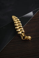 a gold chain on top of a black piece of paper