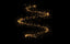 a black background with a swirl of gold glitter