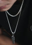 a woman wearing a black shirt and a silver necklace