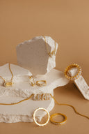 a couple of rings sitting on top of a rock