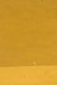 a man riding a skateboard down a street next to a yellow wall