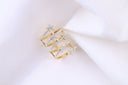 a pair of diamond rings sitting on top of a white cloth