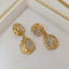 a pair of gold and diamond earrings