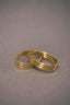 a couple of gold rings sitting on top of a table