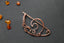 a close up of a piece of jewelry on a table