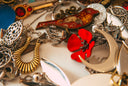 a table topped with lots of different types of jewelry
