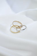 a couple of rings sitting on top of a white sheet