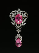 Ornate antique brooch with pink gemstones and diamonds