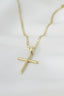 A gold necklace with a cross on it