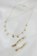 A necklace and earring set on a white sheet