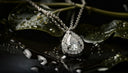 A close up of a necklace on a leaf
