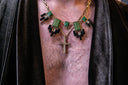 A man wearing a necklace with a cross on it
