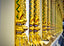 A long row of gold bracelets in a store