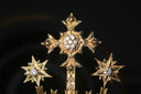 A golden crown with a cross on top of it