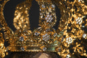 A gold crown with diamonds on top of it