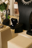 Jewelry display featuring rings and a necklace.