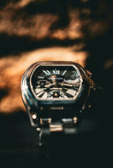 A cartier watch is displayed in close-up.