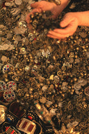 Hands shower glittering gold coins and jewels.