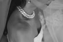 Bride wearing pearls and a wedding dress.