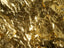 Close-up of crumpled gold foil reflecting light