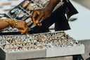 Hands browsing through eyeglasses at a watch and jewelry display.