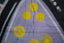 Graffiti art with purple and yellow circles on wall.