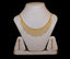 Gold necklace and matching earrings on display.