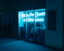 Neon sign glows blue in a jewelry store window